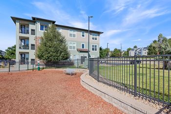 A large apartment complex with a playground in front.
